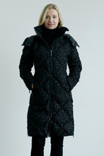 Load image into Gallery viewer, Woman wearing a long black coat with a patterned design on a light gray background
