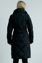 Load image into Gallery viewer, Person wearing a black patterned coat on a light gray background
