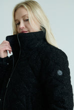 Load image into Gallery viewer, Woman wearing a black coat with a visible brand logo on a light gray background
