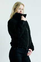 Load image into Gallery viewer, Person wearing a black knit sweater against a plain background
